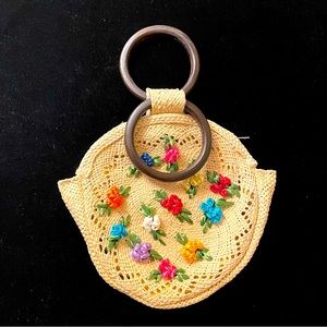 Whimsical, vintage, tiny straw purse with multicolor flowers.